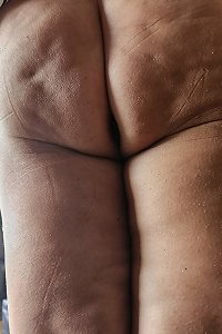 voluptuous young dame temptingly caressing her body