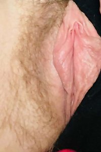 Round, voluptuous girl passionately pleasuring herself